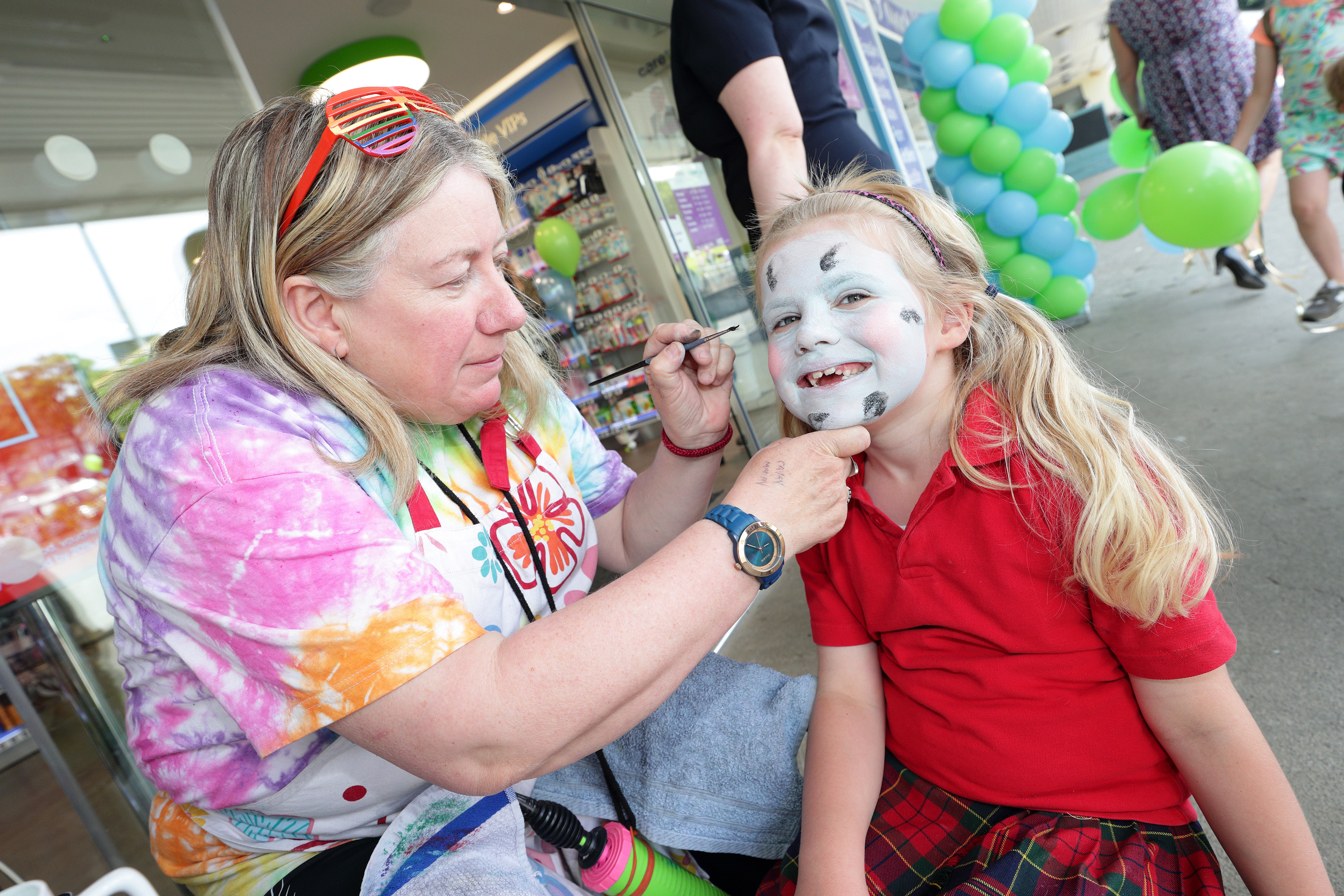 face painter painting young girl's face at Park CarePlus Pharmacy Cabinteely grand opening